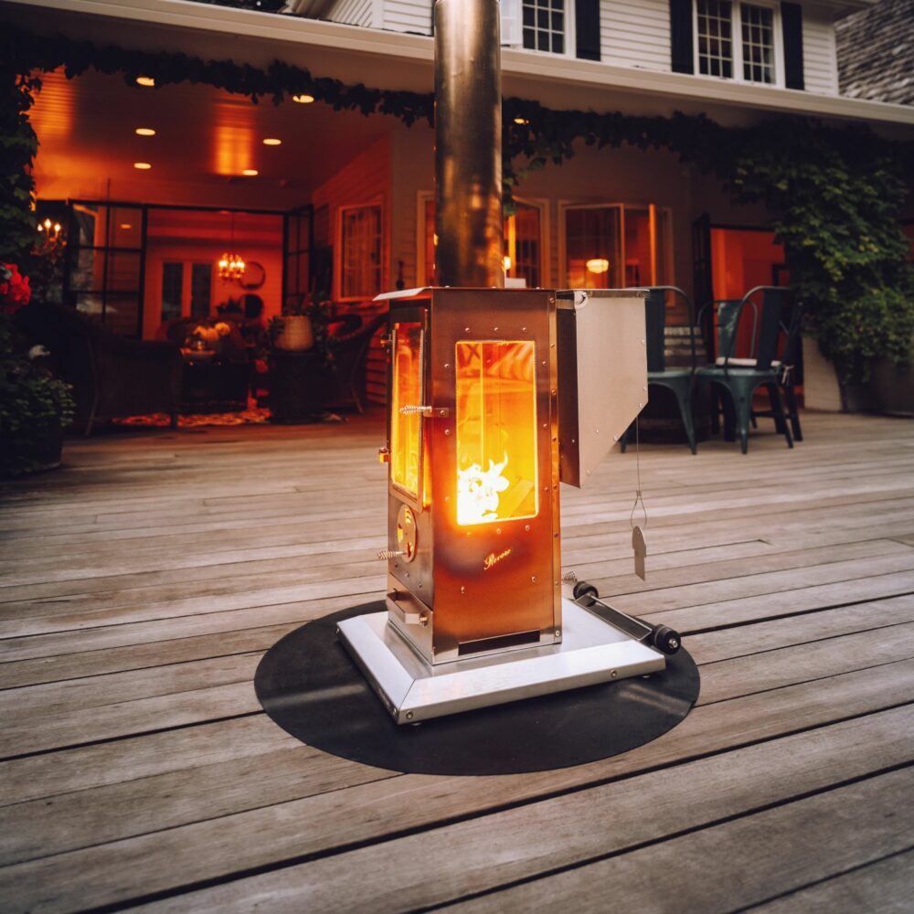 Revere Large Outdoor Fireplace – Now Available at Sundek of Charlotte The Revere Large Outdoor Fireplace, proudly offered by Sundek of Charlotte, combines exceptional heating power with a sleek, modern design to elevate any outdoor space. This 90,000 BTU free-standing heater is perfect for large patios or backyards, providing a 12-ft heating radius and an inviting ambiance for gatherings of any size. Crafted from 100% stainless steel, the Revere Fireplace is built for durability and style. Its three-sided viewing windows, measuring 7.5” x 14.5”, allow everyone to enjoy the mesmerizing flames, creating a warm and welcoming environment. Completely non-electric and portable, it operates using gravity and natural draft, making it a convenient and reliable heating solution.