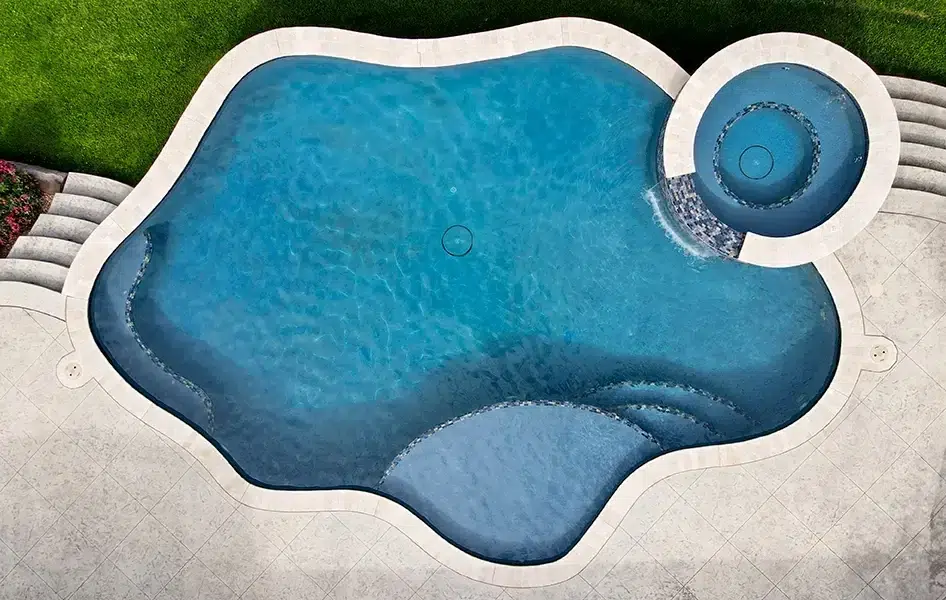 Aerial view of a freeform aquaBRIGHT pool with a circular spa