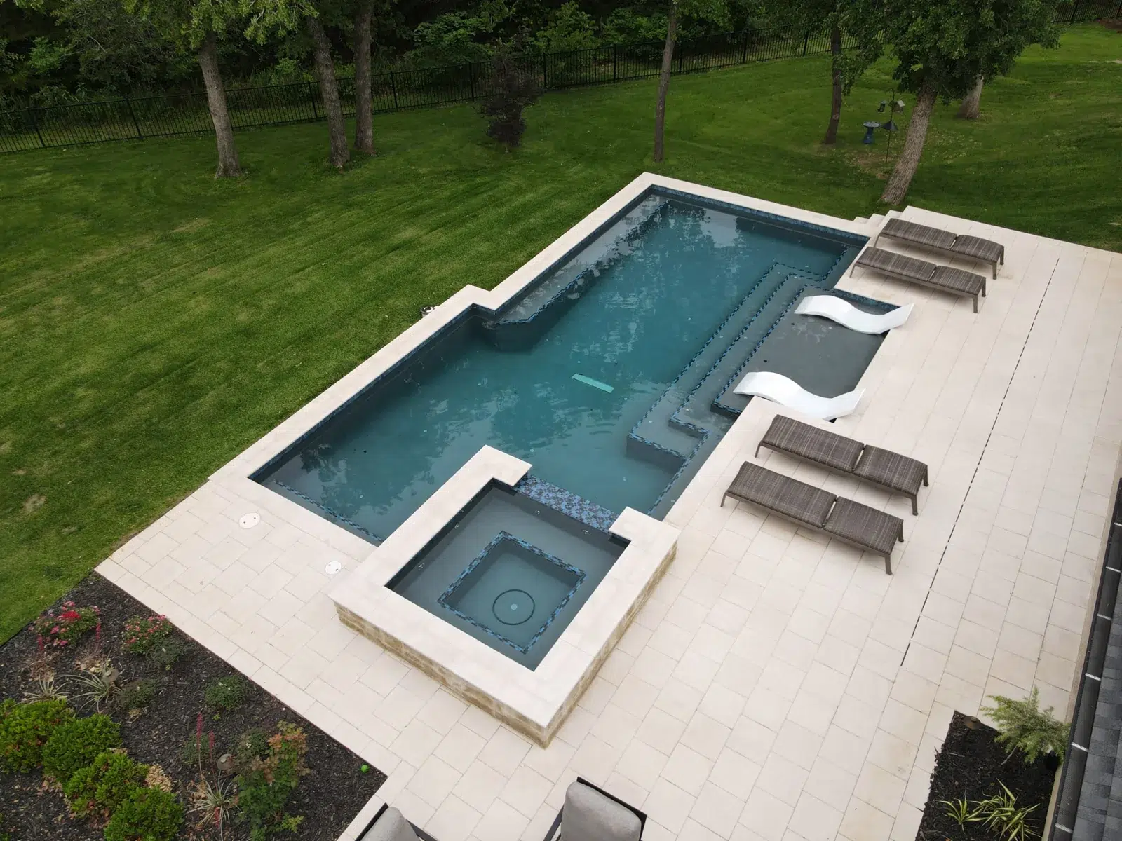 Aerial view of a gray-finish swimming pool, spa and tanning ledge